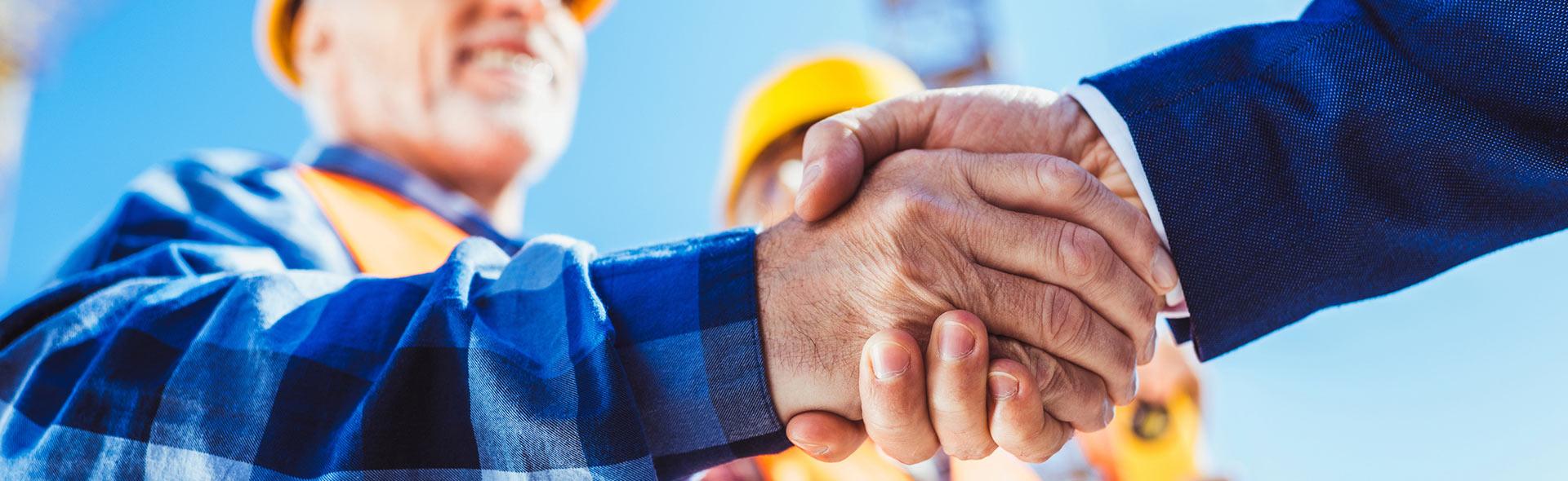 A licensed structural engineer shaking hands with a business owner in Hallandale Beach